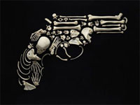 An artistic reproduction of a gun made from human bones